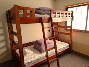two bunk beds in a room with a window at K's House Takayama Oasis [2nd K's Hostel] in Takayama +45 photos