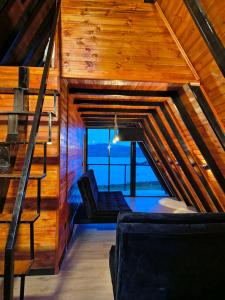 a room with a staircase in a wooden house at Chalets Nisa- lago de tota in Tota