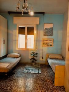 a room with two beds and a window at Bed and Break fast JIREH in Casalecchio di Reno