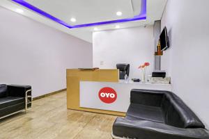 a waiting room with two chairs and aype sign at Hotel O Fox Guest House in Greater Noida