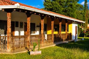 a house with a porch with columns at Looking Samaipata Habitación Doble in Samaipata +17 photos