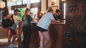 a group of people standing at a bar at Coffee Tree Boutique Hostel in Salento