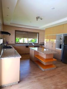 a large kitchen with a large island in the middle at Villa in Meknès