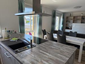a kitchen with a counter top and a table at Kornspeicher in Nörten-Hardenberg +11 photos