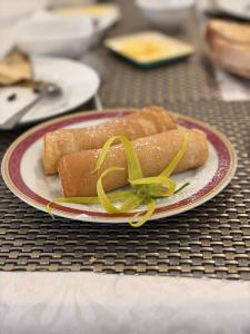 a plate with two hot dogs on a table at New Mavida Lodge in Levuka