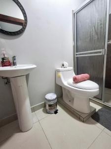a bathroom with a toilet and a sink and a shower at Hotel Zabdy in Liberia