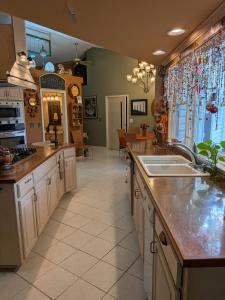 a kitchen with a sink and a counter top at FIFA Basecamp with 2 Kitchens, 5BR, 4 Baths in Roeland Park