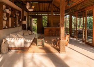 a living room with a couch and a table at Surya Shanti Villa Sidemen in Sidemen +55 photos
