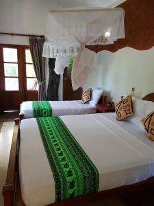 Letto o letti in una camera di Sigiri Heritage Villa