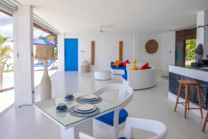 a living room with a table and chairs at NEW! 2BR Ocean View, Infinity Pool, Villa Kerylos in Sampalan
