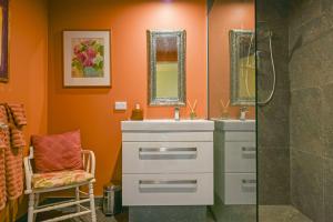a bathroom with a shower and a white sink at Ballymoney Cnoc in Tai Tapu
