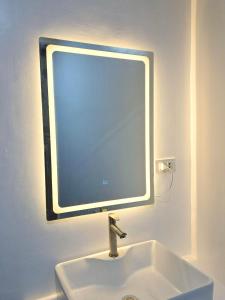 a bathroom sink with a large mirror above it at Villa Luyo in General Luna