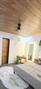 a bedroom with a bed and a wooden ceiling at Villa Luyo in General Luna +2 photos