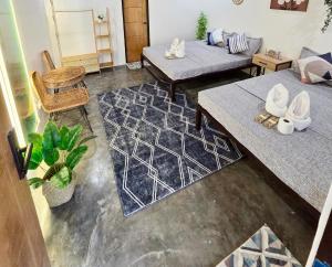 a living room with two couches and a table at Villa Luyo in General Luna