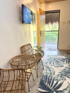 a room with two chairs and a table and a tv at Villa Luyo in General Luna