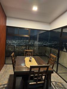 a table and chairs on a balcony with a view at Villas Amíwa in Alajuelita +26 photos