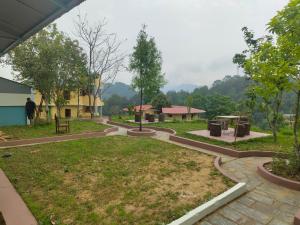a view of a park with trees and buildings at Balthali Heritage Inn Resort in Panaoti