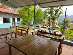 a group of tables and benches on a balcony at Balthali Heritage Inn Resort in Panaoti