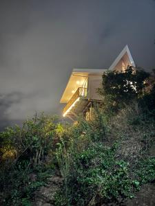a house on top of a hill in the fog at Villas Amíwa in Alajuelita