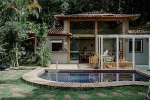 a house with a swimming pool in front of it at Villa Don in Petrópolis