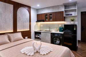 a bedroom with a bed with a washer and dryer at Marly Apartment in Danang
