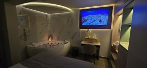 a bathroom with a tub and a tv on the wall at HB Selection Hotel in Miraflores +40 photos