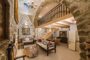 a living room with a stone wall and a staircase at Casa Daria in Topólia