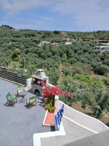 a balcony with a table and chairs and flowers at Villa Krini in Skiathos