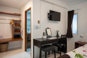 a room with a desk and a bed and a bedroom at The Cosy Maenam Beach Resort in Mae Nam