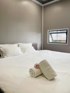 a towel on a bed with a teddy bear on it at Hanoi Quarter Life Hostel in Hanoi