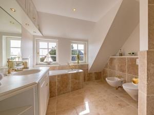 a large bathroom with a sink and a toilet at Leuchtturmblick-Sued in Kampen +21 photos