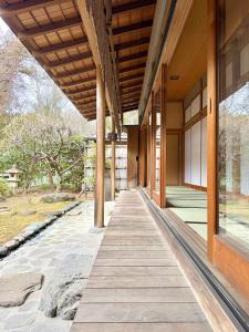 an external view of a building with a wooden walkway at ccb hotel 90Minutes from Tokyo in Chichibu +24 photos