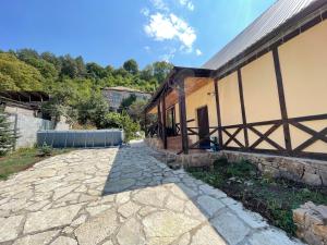 a stone walkway next to a building at Jelini Villa in Dilijan
