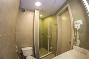 a bathroom with a shower and a toilet at Ibis Florianopolis in Florianópolis