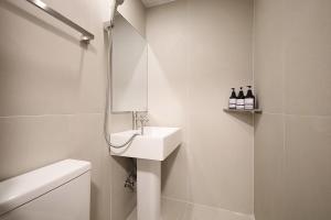 a white bathroom with a sink and a shower at Hotel Soonsu Mia in Seoul +34 photos