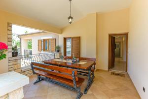 a dining room with a bench and a balcony at Family Villa Krizanci Istria in Žminj