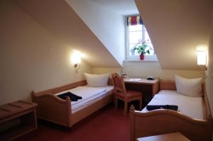 a room with two beds and a desk and a window at Hotel Alttolkewitzer Hof in Dresden +56 photos