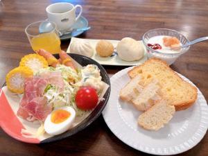a table with two plates of food with eggs and bread at 北軽井沢 あさま1155 Kita Karuizawa Asama1155 in Tsumagoi
