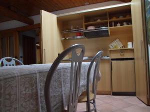 uma cozinha com mesa e cadeiras num quarto em Agritur Fior di Melo em Nanno