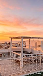 a view from the deck of a pier at sunset at Dar Baaziz 3 in Sousse
