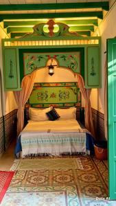 a bedroom with a large bed with a canopy at Dar Baaziz 3 in Sousse