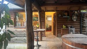 a porch of a wooden cabin with a wooden table at Srub u Krále in Dobruška