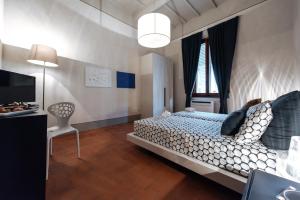 a bedroom with a large bed and a television at Residenza Cavour in Empoli