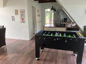 a ping pong table in the middle of a living room at Penthouse deluxe in Hobro