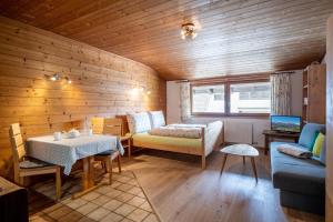 a living room with a table and a couch at App. Fam. Dr. Goldberger in Söll