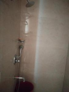 a shower stall with a toilet in a bathroom at The kanha Luxury Suites in Greater Noida