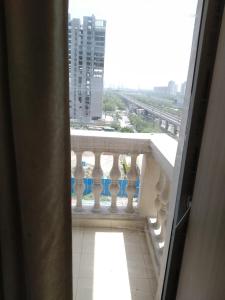a balcony with a view of a building at The kanha Luxury Suites in Greater Noida