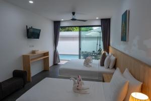 a bedroom with a bed and a living room at The Cosy Maenam Beach Resort in Mae Nam +79 photos