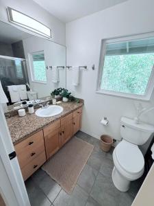 a bathroom with a toilet and a sink and a window at Kona Kai Ocean View Suite in Kailua-Kona +15 photos