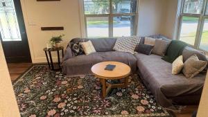 a living room with a couch and a table at The Hangout House With Bonus Game Room & Foosball in Coeur d'Alene